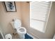 Bright bathroom featuring a toilet with a new toilet paper roll and sunlit window at 2780 E Sam Allen Rd, Plant City, FL 33565