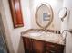 Charming bathroom features granite countertops, custom wood cabinets and gold framed mirror at 2780 E Sam Allen Rd, Plant City, FL 33565