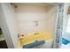 Bathroom showcasing a yellow tub and tiled walls, enhanced by natural light at 2780 E Sam Allen Rd, Plant City, FL 33565