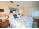 Comfortable bedroom featuring a large mirror, patterned bedding and ample closet space at 2780 E Sam Allen Rd, Plant City, FL 33565