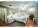Bright primary bedroom features hardwood floors and a large window offering natural light at 2780 E Sam Allen Rd, Plant City, FL 33565