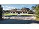 Lovely home with a well-kept lawn, a gated driveway, and a charming front entrance at 2780 E Sam Allen Rd, Plant City, FL 33565