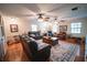 Spacious living room with hardwood floors, ceiling fans, neutral walls, and comfortable seating at 2780 E Sam Allen Rd, Plant City, FL 33565