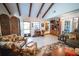Inviting living room with tiled floors, vaulted ceiling, wooden beams, and easy access to the entryway at 2780 E Sam Allen Rd, Plant City, FL 33565
