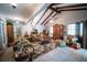 Bright living room with vaulted ceilings, exposed beams, and cozy seating arrangement on a decorative rug at 2780 E Sam Allen Rd, Plant City, FL 33565