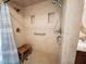 Accessible shower with tile surround, built-in niches, grab bar and comfortable wooden bench at 2780 E Sam Allen Rd, Plant City, FL 33565
