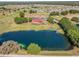 Aerial shot of the community clubhouse, overlooking a picturesque pond and golf course at 31076 Castle Ridge Drive, Brooksville, FL 34602