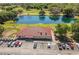 Overhead view of the clubhouse, lake, parking and golf course, creating a desirable recreational setting at 31076 Castle Ridge Drive, Brooksville, FL 34602