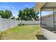 Expansive backyard featuring a verdant lawn, privacy fence, and partial view of the home's exterior at 31076 Castle Ridge Drive, Brooksville, FL 34602