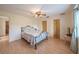 Bright bedroom featuring a metal bed frame, wood look flooring, ceiling fan, and good natural light at 31076 Castle Ridge Drive, Brooksville, FL 34602