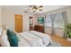 Tranquil bedroom with a ceiling fan, wood floors, and large windows with curtains at 31076 Castle Ridge Drive, Brooksville, FL 34602