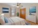 Comfortable bedroom featuring calming blue accents, light-colored walls, and wood laminate flooring at 31076 Castle Ridge Drive, Brooksville, FL 34602
