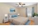 Serene bedroom with blue accents, light-colored walls, and wood laminate flooring at 31076 Castle Ridge Drive, Brooksville, FL 34602