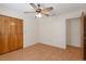 Neutral bedroom with wood laminate flooring and a ceiling fan, offering a simple design at 31076 Castle Ridge Drive, Brooksville, FL 34602