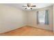 Bright bedroom with wood laminate flooring, a ceiling fan, and a window for natural light at 31076 Castle Ridge Drive, Brooksville, FL 34602