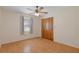 Bright bedroom with wood laminate flooring, a ceiling fan, and a window for natural light at 31076 Castle Ridge Drive, Brooksville, FL 34602