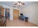 This bedroom has wood floors, closet, desk, ceiling fan and an open doorway to the kitchen at 31076 Castle Ridge Drive, Brooksville, FL 34602