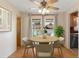 Cozy dining area with a round table, stylish chairs, and natural lighting at 31076 Castle Ridge Drive, Brooksville, FL 34602