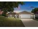 Charming single-story home with well-maintained lawn and attached two-car garage at 31076 Castle Ridge Drive, Brooksville, FL 34602