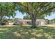 Charming single-story house nestled among mature trees with a well-kept lawn at 31076 Castle Ridge Drive, Brooksville, FL 34602