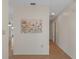 Hallway featuring laminate floors and a floral decorative art piece on the wall at 31076 Castle Ridge Drive, Brooksville, FL 34602