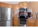 Bright kitchen with stainless steel appliances, microwave, and a breakfast bar at 31076 Castle Ridge Drive, Brooksville, FL 34602