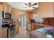 Kitchen features stainless steel appliances, light wood cabinets, and decorative backsplash at 31076 Castle Ridge Drive, Brooksville, FL 34602