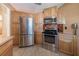 Functional kitchen featuring stainless steel appliances and ample wooden cabinetry at 31076 Castle Ridge Drive, Brooksville, FL 34602