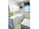 Functional laundry room featuring a sink, washer, dryer, and overhead cabinets for organization at 31076 Castle Ridge Drive, Brooksville, FL 34602