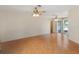 Spacious living room with laminate floors, ceiling fan, and sliding glass door at 31076 Castle Ridge Drive, Brooksville, FL 34602