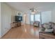 Inviting living room features hardwood floors, ceiling fan, and a comfortable seating area at 31076 Castle Ridge Drive, Brooksville, FL 34602
