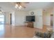 Open living room with hardwood floors, ceiling fan, and view of the outdoor area at 31076 Castle Ridge Drive, Brooksville, FL 34602
