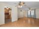 Spacious living room with ceiling fans, views into the kitchen, and light-colored wood floors at 31076 Castle Ridge Drive, Brooksville, FL 34602