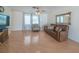 Open living room featuring wood-look flooring, comfortable seating, and natural light from windows at 31076 Castle Ridge Drive, Brooksville, FL 34602