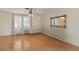 Bright living room with light-colored wood floors, neutral paint, and large decorative mirror at 31076 Castle Ridge Drive, Brooksville, FL 34602
