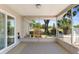Enjoy the beautiful view from this screened-in patio with neutral colors and a decorative rug at 31076 Castle Ridge Drive, Brooksville, FL 34602