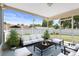 Relaxing screened patio with comfortable seating and view of well-maintained yard at 31076 Castle Ridge Drive, Brooksville, FL 34602