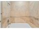Elegant bathroom tub and shower with tiled walls at 321 Brightwaters Ne Blvd, St Petersburg, FL 33704