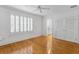 Bedroom with a ceiling fan, hardwood floors, and shuttered windows allowing natural light at 321 Brightwaters Ne Blvd, St Petersburg, FL 33704