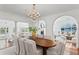 Formal dining room boasting a crystal chandelier and views to the backyard and multiple rooms at 321 Brightwaters Ne Blvd, St Petersburg, FL 33704
