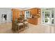 Charming eat-in kitchen featuring knotty wood cabinets, a center island, and access to the backyard at 321 Brightwaters Ne Blvd, St Petersburg, FL 33704