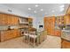 Bright eat-in kitchen with custom wood cabinetry, granite counters, a central island and stainless appliances at 321 Brightwaters Ne Blvd, St Petersburg, FL 33704