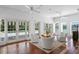 Bright living room featuring tile floor, white chairs, ceiling fans, and pool views through french doors at 321 Brightwaters Ne Blvd, St Petersburg, FL 33704