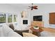 Inviting living room with a fireplace, TV, plush sectional, and views to the lush backyard at 321 Brightwaters Ne Blvd, St Petersburg, FL 33704