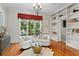 Cozy sitting room with stylish decor, including white chairs, a gold table, and built-in shelving at 321 Brightwaters Ne Blvd, St Petersburg, FL 33704