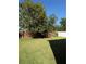 Backyard featuring a well-maintained lawn and brick fence at 32111 Brookstone Dr, Wesley Chapel, FL 33545