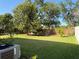 Backyard featuring a well-maintained lawn and brick fence at 32111 Brookstone Dr, Wesley Chapel, FL 33545