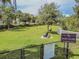 Dog park with green grass and a sign with rules and regulations at 32111 Brookstone Dr, Wesley Chapel, FL 33545