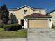 Two-story home with a neutral color palette and a two car garage in a suburban neighborhood at 32111 Brookstone Dr, Wesley Chapel, FL 33545