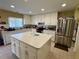 Traditional kitchen with a large center island and stainless steel refrigerator at 32111 Brookstone Dr, Wesley Chapel, FL 33545